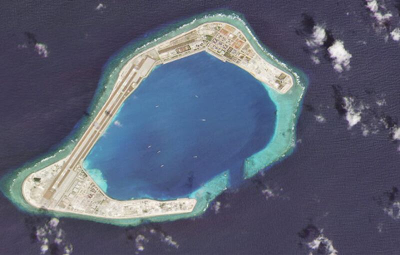 A satellite image taken Feb. 28, 2020 shows vessels at Subi Reef, an artificial island constructed by China in the Spratly island chain in the South China Sea. Chinese ships can only sustain their pressure campaigns far from mainland China if they can dock and replenish at such locations. 